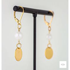 Mystic moonstone gold disc drop earrings from Miel Jewelry! These cute earrings are a modern and stylish addition to any outfit. The smooth and shimmery white mystic moonstone beads are so sweet and pretty! They are paired perfectly with these gold-plated circular drops. They have gold-plated sterling silver lever backs for a secure and comfortable fit. 1.75 inches in length. If you are looking for the perfect gift or just want to treat yourself, these lightweight and shimmery Mystic moonstone g Elegant Gold Earrings With Moon Charm, Elegant Moon-shaped Earrings For Gift, Elegant Moon-shaped Jewelry With Matching Earrings, Elegant Single Moon-shaped Earring, Elegant Moon Shaped Single Earring, Elegant Moon-shaped Wedding Earrings, Elegant Moon Shaped Wedding Earrings, Elegant Moon Charm Drop Earrings, Elegant Brass Earrings With Moon Charm