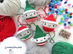 crocheted christmas ornaments with yarn and balls of yarn in the background on a table