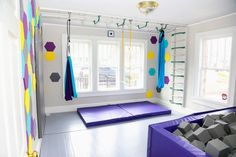 an exercise room with yoga mats and colorful decorations