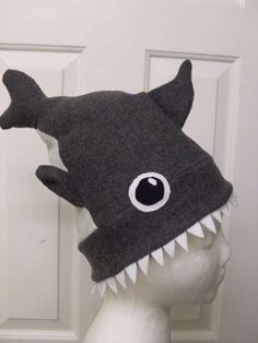 a gray hat with a shark's teeth on it