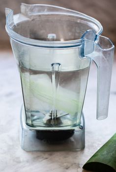 a blender filled with liquid sitting on top of a counter