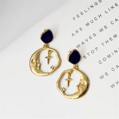 Infuse bohemian-inspired flair into your wardrobe with this pair of hoop earrings boasting a quirky crescent moon design. 1.1'' W x 1.69'' L Goldtone copper / enamel / cubic zirconia Moon Face Earrings, Crescent Moon Design, Vintage Drop Earrings, Moon And Star Earrings, Moon Face, Face Earrings, Gold Moon, Party Earrings, Star Moon