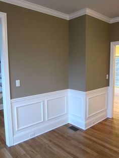 an empty room with hard wood floors and white wains on the walls, painted in neutral colors