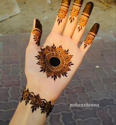 a woman's hand with henna tattoos on it and an eye in the middle