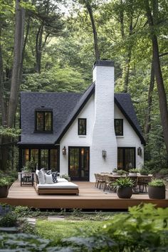 a white house in the woods surrounded by trees