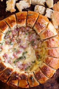 ham and cheese pull apart bread bowl on a wooden table with crackers around it