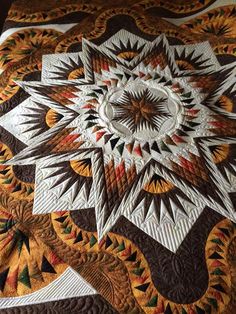 a quilted table topper with an intricate design on it