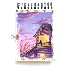 a notebook with a drawing of a house at night