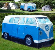 a blue and white vw bus sitting in the grass