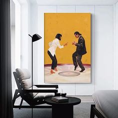 two people are dancing on the ice in front of a yellow wall and black chair