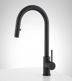 a black kitchen faucet on a white counter top with the handle extended to it's left side