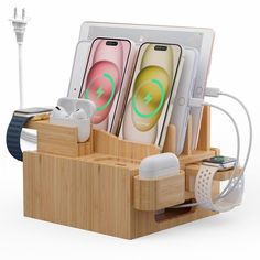 an iphone charging station with three phones in it