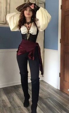 a woman in a costume posing for the camera with her hands on her head and wearing boots