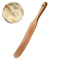 a wooden spoon with cream in it next to a bowl