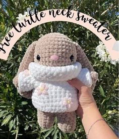 a crocheted bunny holding a stuffed animal with the words free little nek sweater on it