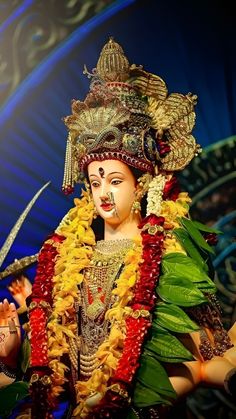 a statue of a woman with flowers on her head