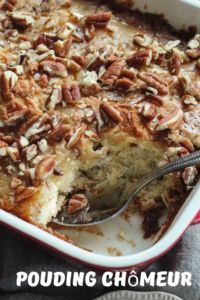 a close up of a casserole with pecans on top and a spoon in it