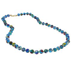 Add a touch of classic Venetian style to your outfit with this elegant Murano millefiori necklace. Centuries-old Murano glass technique perfected by Italian master craftsmen is used to create colorful mosaic effect that is fun and trendy, yet classic and timeless. This is a unique necklace that will add Venetian chic to your jewelry collection and will brighten up your look and your day. Measurements: Each necklace measures 24 inches in length and comes with an attractive velvet pouch and a cert Multicolor Murano Glass Round Necklace, Turquoise Single Strand Glass Necklace, Blue Murano Glass Round Jewelry, Blue Single Strand Murano Glass Beaded Necklace, Turquoise Round Glass Necklaces, Blue Round Glass Necklaces, Blue Glass Round Necklaces, Blue Murano Glass Jewelry With Colorful Beads, Blue Murano Glass Single Strand Necklace