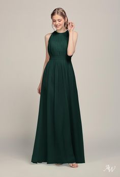 a woman wearing a dark green bridesmaid dress with an open back and pleaed skirt