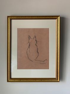 a drawing of a cat is hanging on the wall