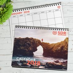 two calendars sitting next to each other on a table