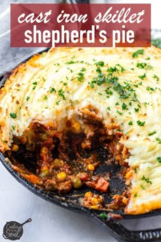 a cast iron skillet filled with shepherd's pie on top of a table