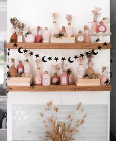 the shelves are filled with different types of bottles and decorations on them, along with some dried flowers