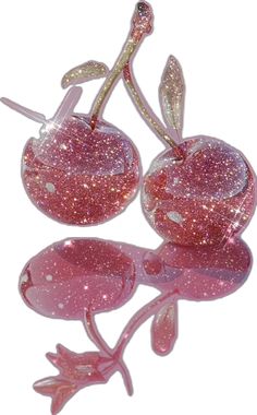 two pink glass cherries sitting on top of each other