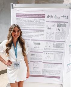 a woman standing in front of a poster