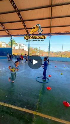 children playing with frisbees in an indoor gym