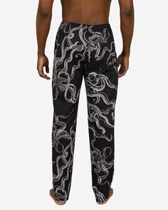 Dive into unique style and unmatched comfort with our Octopus Black Men's Lounge Pants, featuring whimsical white octopuses set against a sleek black background. Features: Roomy front pockets and a convenient back pocket. Elastic waistband with adjustable drawstring. Exclusive Corozo button fly closure. Made from premium cotton. Benefits: Feel the Difference: Experience the soothing touch of high-quality cotton, perfect for home relaxation. Optimal Airflow: Premium cotton ensures you stay cool and comfortable. Consciously Crafted: Support sustainable fashion with every purchase towards an eco-friendly lifestyle. The 'Octopus Black' Collection - Embrace the captivating charm of our Octopus Black collection. Discover more at Octopus Black Collection. Mens Lounge Pants, Lounge Pants, Slow Fashion, Octopus, Natural Cotton, Black Backgrounds, Sustainable Fashion, Black Men, Tshirt Print