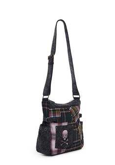 This messenger bag has a twill construction with a plaid patchwork design, ball stud detailing, adjustable shoulder straps, side pockets with grommet details, decorative side straps, a small front square pocket with a skull patch, a cutout star design on back, a back zippered pocket, and a top zipper closure. Grunge Bags With Adjustable Strap For Alternative Fashion, Punk Style Shoulder Bag With Adjustable Strap For Travel, Alternative Style Shoulder Bag With Adjustable Strap, Punk Style School Shoulder Bag With Adjustable Strap, Punk Shoulder Bag With Adjustable Strap For School, Alternative Style Crossbody Bag With Adjustable Strap, Alternative Crossbody Bag With Adjustable Strap, Edgy Bags For Everyday Use In Fall, Edgy Everyday Bags For Fall