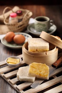 some food is sitting on a table with chopsticks and eggs in the background