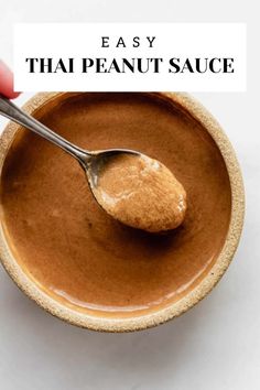 a spoon in a bowl filled with peanut butter