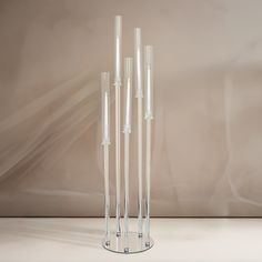 three tall clear vases sitting on top of a table