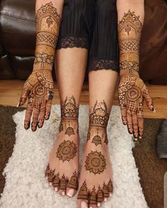 two hands and feet with henna tattoos on them