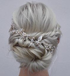 a woman with blonde hair wearing a wedding hairstyle