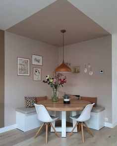 a room with a table, chairs and a large red sign hanging from the ceiling