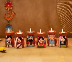 a group of small candles sitting next to each other on top of a wooden table