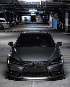 a black sports car parked in a parking garage