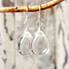 "These remind me of crystal raindrops. A best seller in my shop. Crystal Clear Czech glass briolettes are wire wrapped with sterling silver wire and dangled from sterling ear wires. The briolette size is 10x14mm. The earrings measure 1 1/2\" from the top of the sterling ear wire. Lightweight and comfortable for all day wear. See the larger version here: https://www.etsy.com/listing/1174059675/clear-glass-earrings-large-sterling?click_key=01f2e3f6618863e2a620f381edd1861dae4f1d71%3A1174059675& Clear Crystal Bracelet, Clear Bracelet, Clear Crystal Earrings, Heart Accessories, Semiprecious Stone Jewelry, Clear Earrings, Glass Drop Earrings, Buy Earrings, Teardrop Dangle Earrings