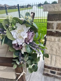 a bouquet of flowers sitting on top of a bench