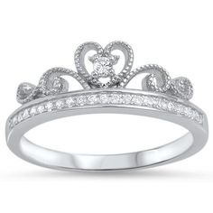 a white gold ring with diamonds on the sides and a heart shaped crown in the middle