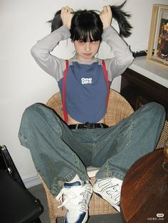 a person sitting on a chair with their hair in the air