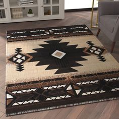 an area rug in the middle of a living room with a chair and bookshelf