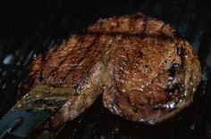 the steak is being cooked on the grill