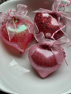 two heart shaped ornaments on a white plate