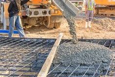 construction workers are pouring concrete onto the ground