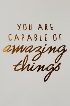 the words you are capable of amazing things written in gold foil on a white background