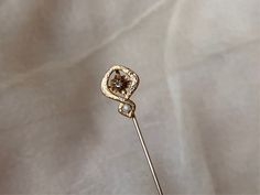 "This enchanting stick pin features a glittering rose-cut mine diamond set in a delicately curved 10k gold art nouveau setting with etched details and a seed pearl at the bottom. It is marked on the back as being 10k gold.  It weighs 1.05 g (without fob), measures 2 3/8\" x 7/16\" and is in great antique condition." Old Wedding, Stick Pins, Seed Pearl, Gold Art, Diamond Set, Diamond Fashion, Bride Bridal, Antique Art, Pin Brooch